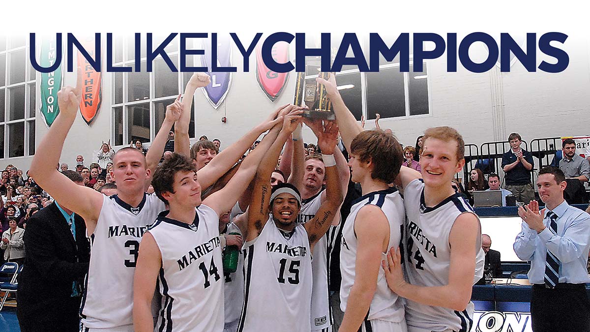 2010 Mens Basketball players holding the trophy in the air