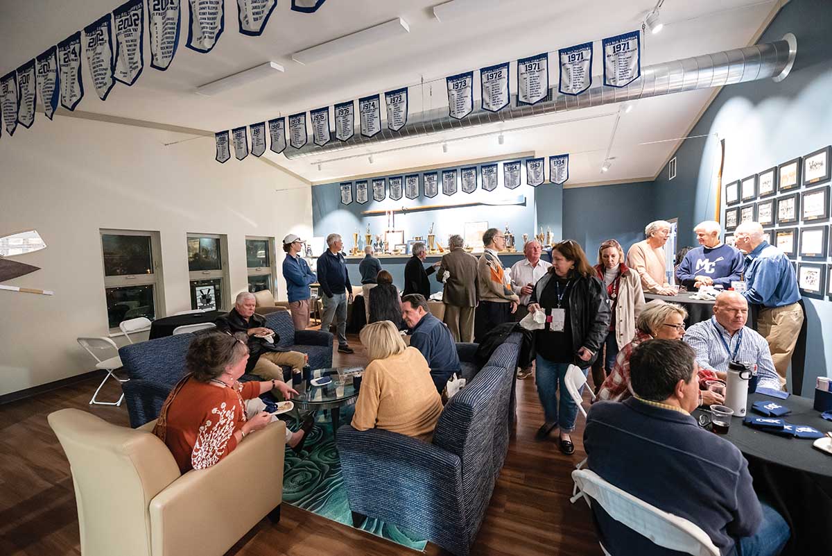 Family and friends enjoy some food and beverages in the Dad Vail Room