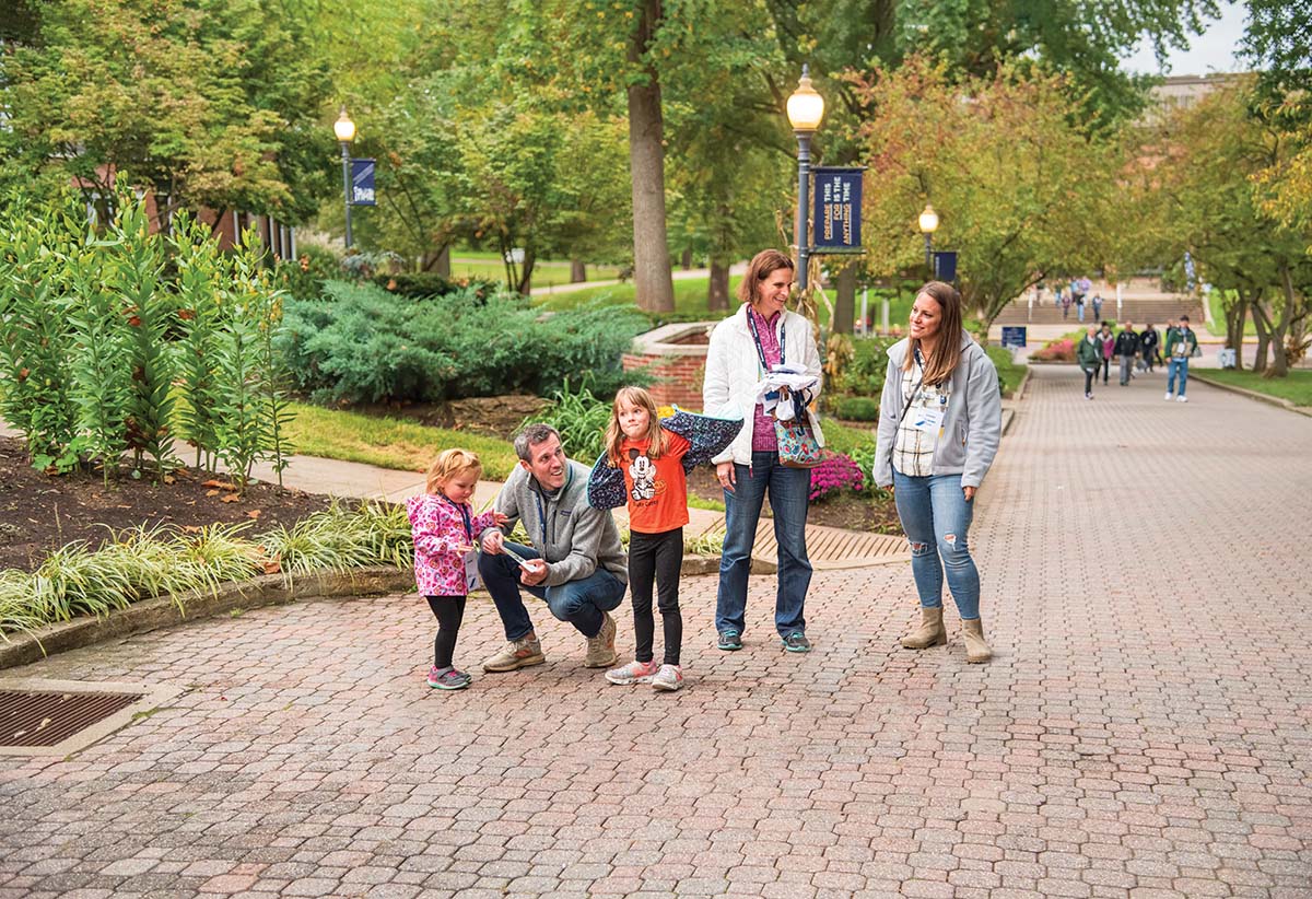 Justin Suttmiller, husband of Lauren Brubaker ’03 (far right) and their daughters, Josie, 5 and Kendall, 2, walk The Christy Mall with Erin Hix ’00 during the All-Alumni Welcome.