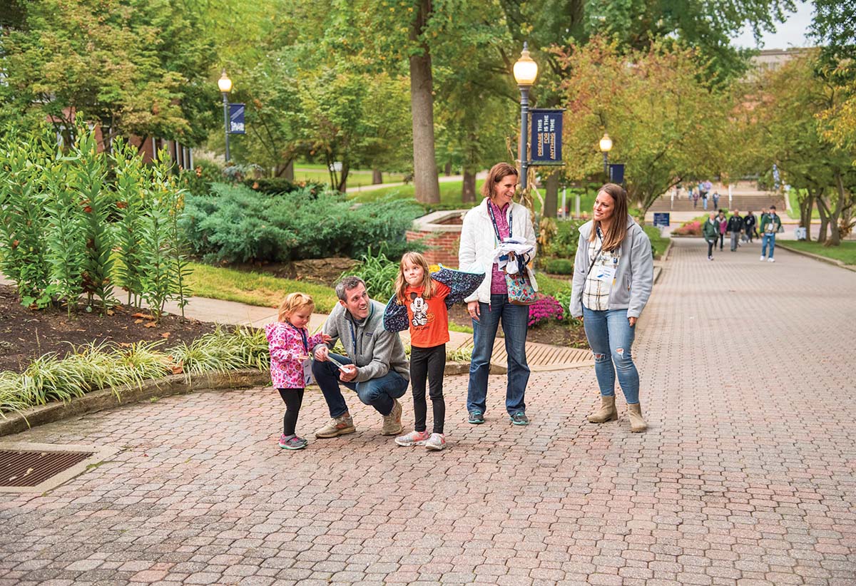 Justin Suttmiller, husband of Lauren Brubaker â03 (far right) and their daughters, Josie, 5 and Kendall, 2, walk The Christy Mall with Erin Hix â00 during the All-Alumni Welcome.
