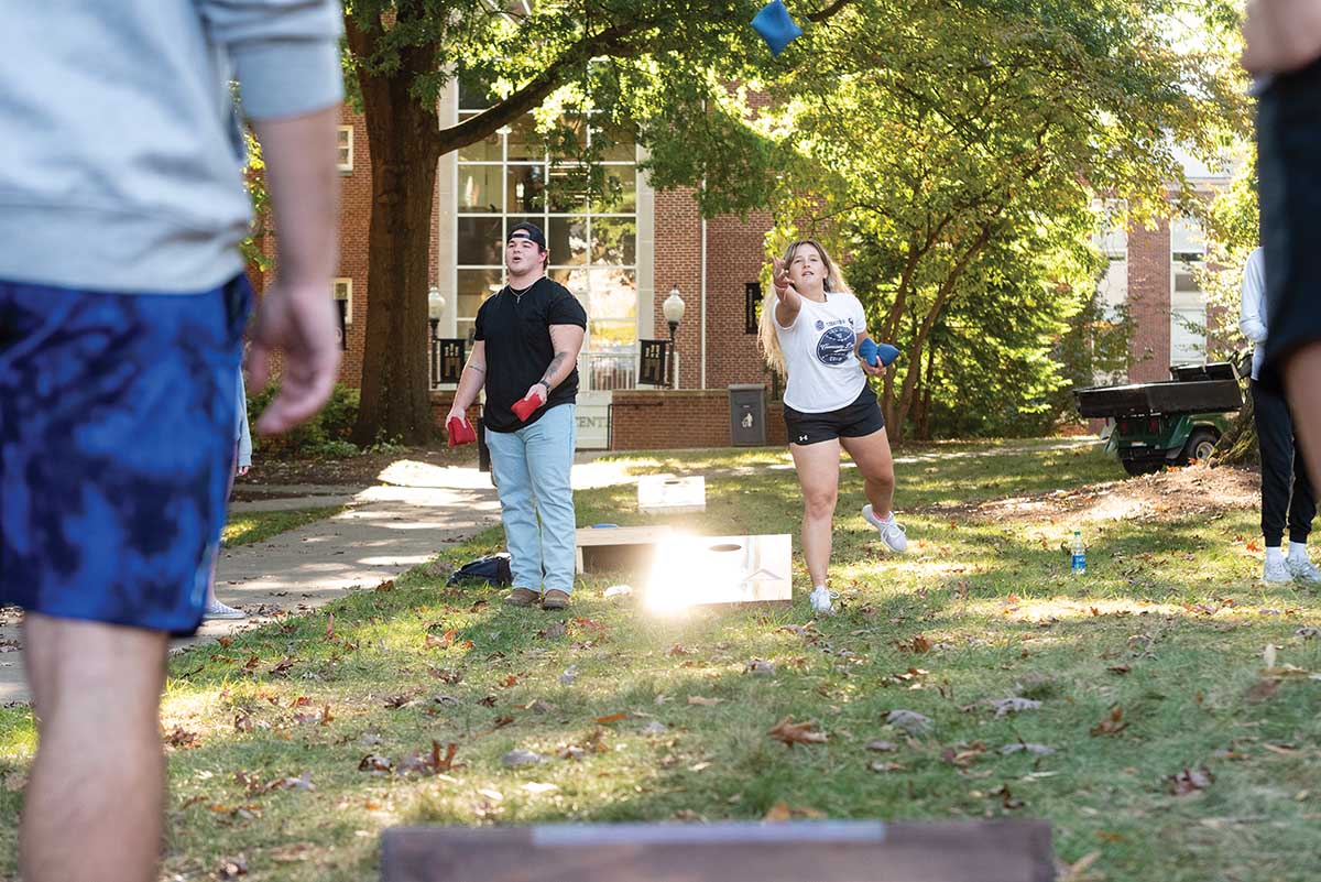 Natalie Payton ’22 plays a round of cornhole — one of many student activities leading up to Homecoming.