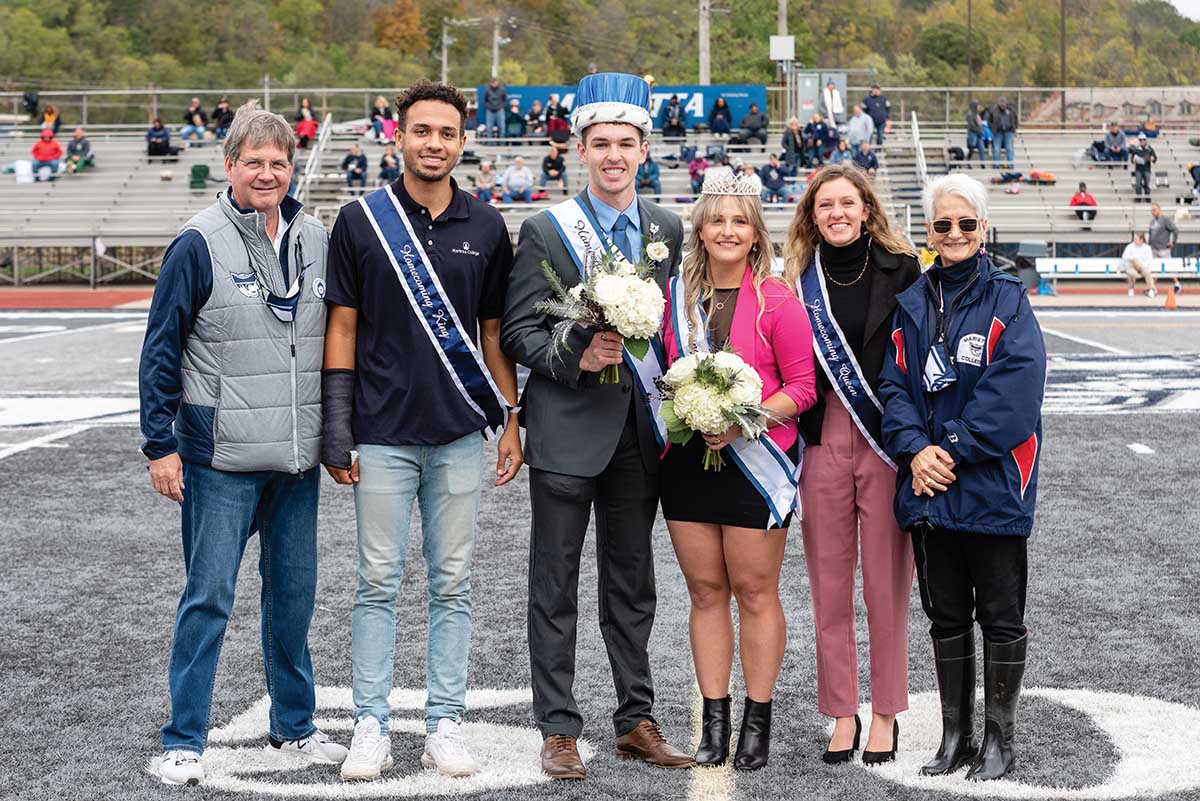 President Bill Ruud and his wife, Judy, stand with newly crowned Homecoming King Tyler Walker â22 and Queen Natalie Payton â22 and 2020 Homecoming King Robert Nelson â21 and Queen Kelsey Hall â21.