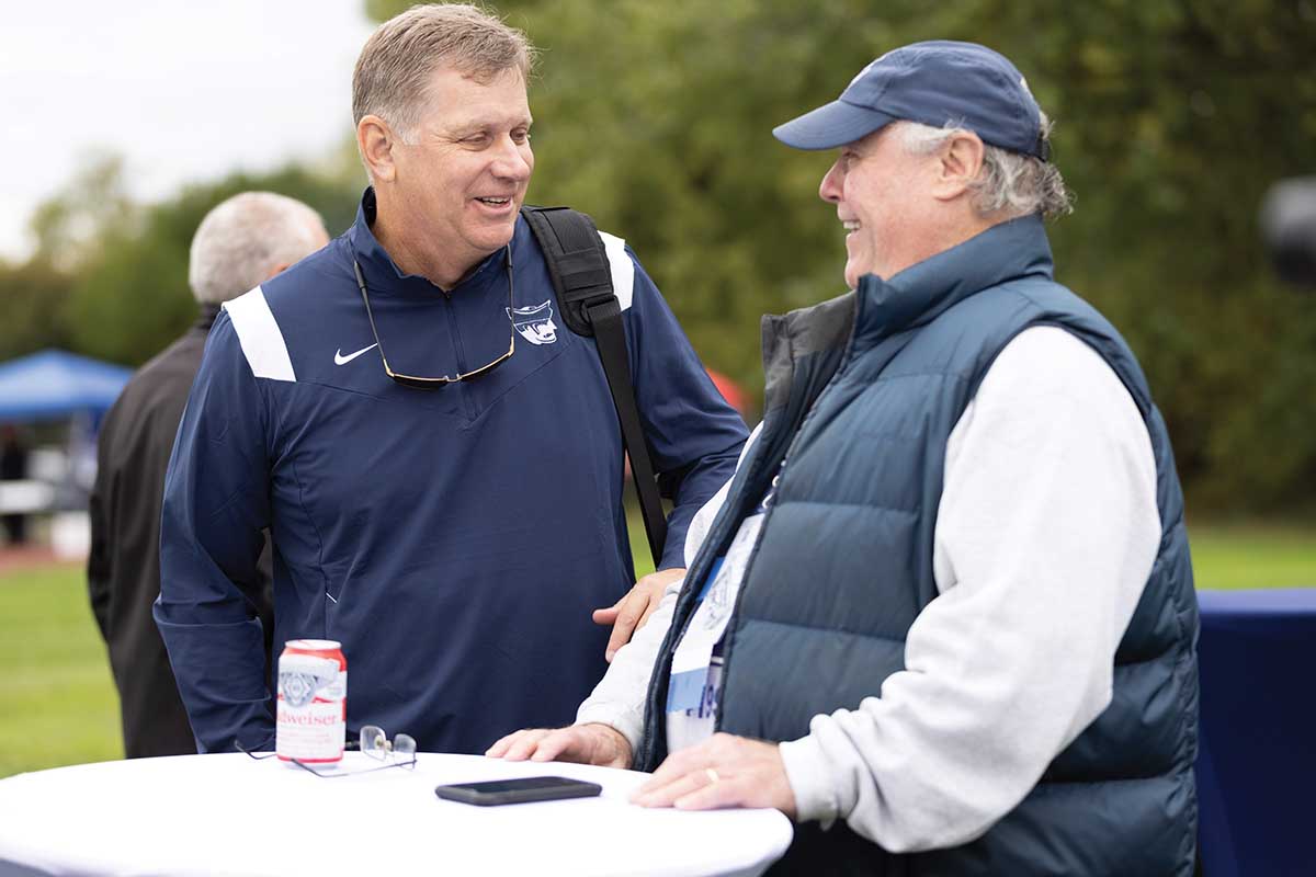 Athletics Director Larry Hiser and John Foster talk during the Homecoming Tailgate