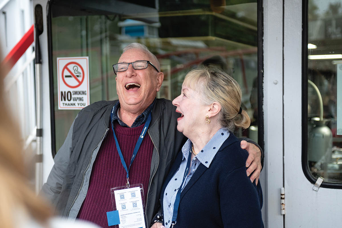 Charlie Dawes â71 and Kathleen Reddy-Smith â71 share a laugh during the river cruise.