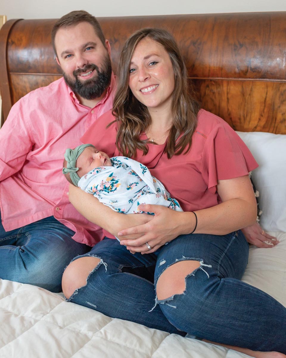 Lyndsay Offenberger Monk '10 and Jason Monk '10 pose with their new baby Audree