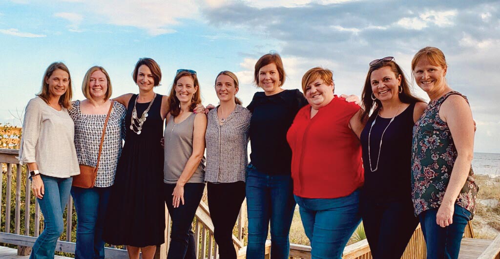 A group photo of 9 Marietta College Alumnae at the beach