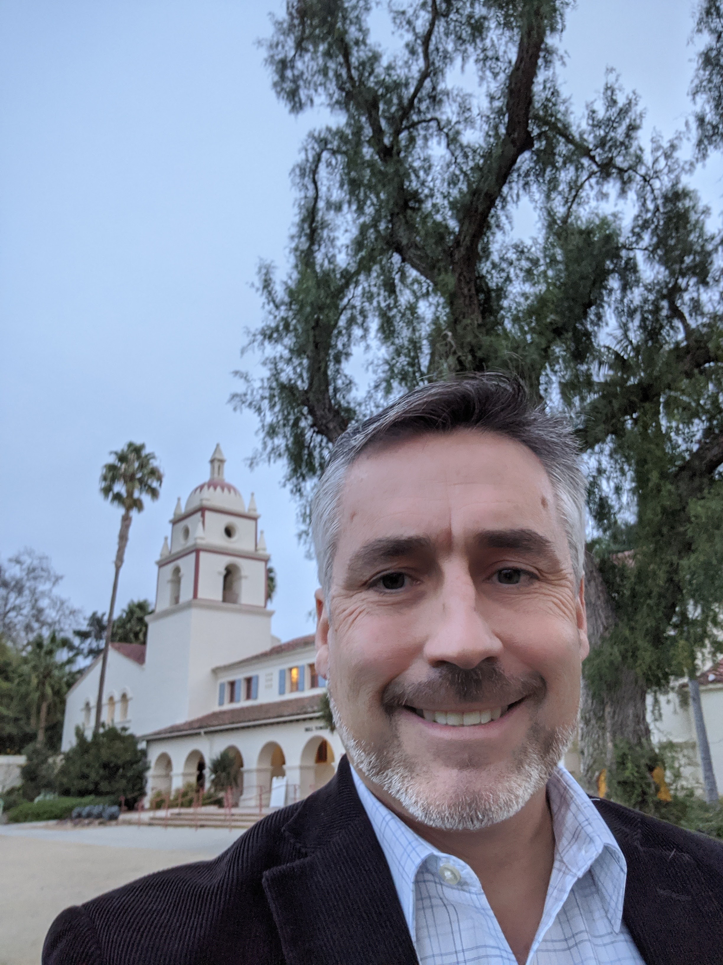 Mark Patterson '89 selfie in front of a building