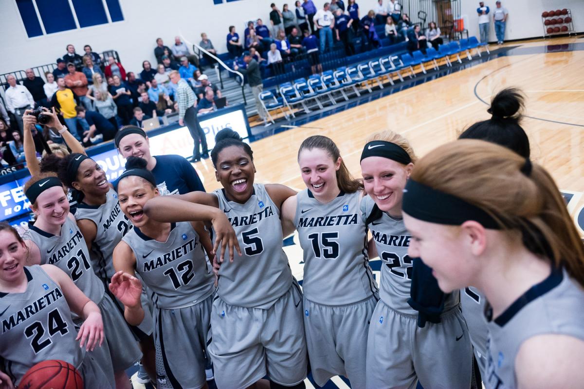 Marietta College Womens Basketball celebrating in a circle