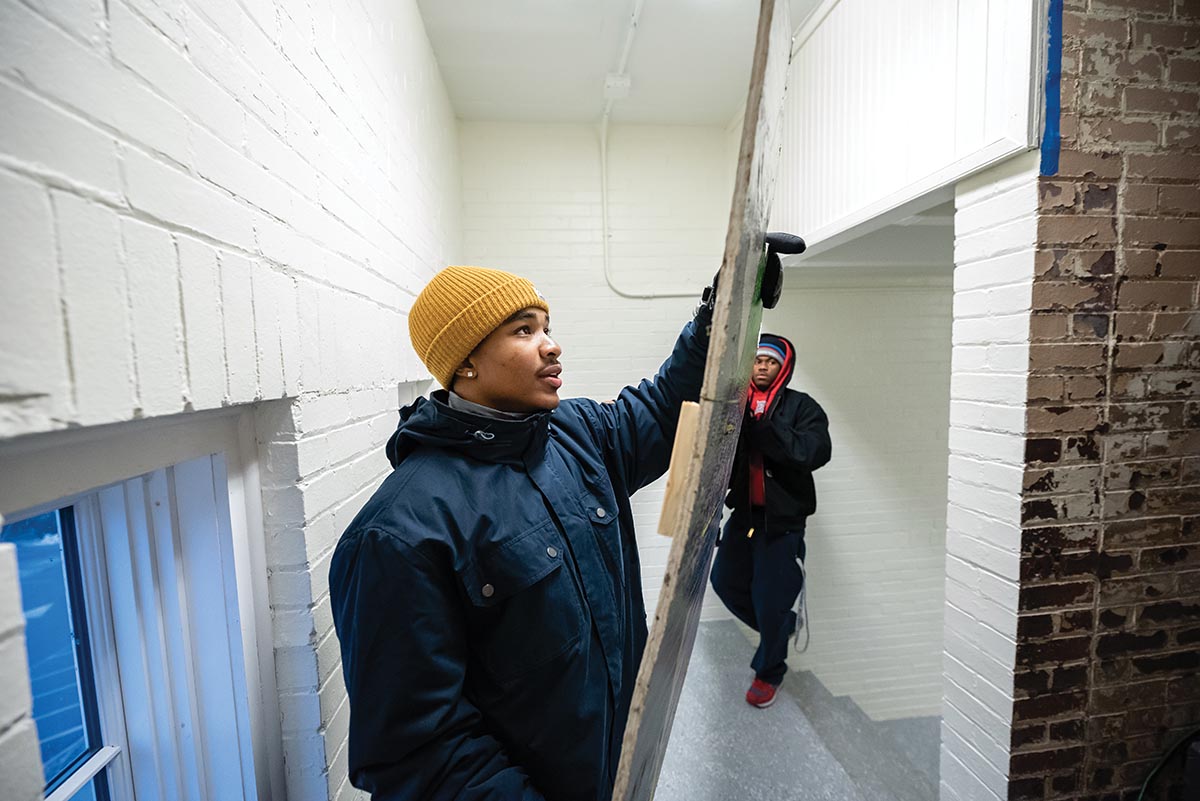 Nate Hinckley ’22 (left), Ty’Reik Martin ’22 and fellow members of Marietta College’s Brother 2 Brother organization spent an evening helping Marietta Main Street remove downtown holiday decorations.