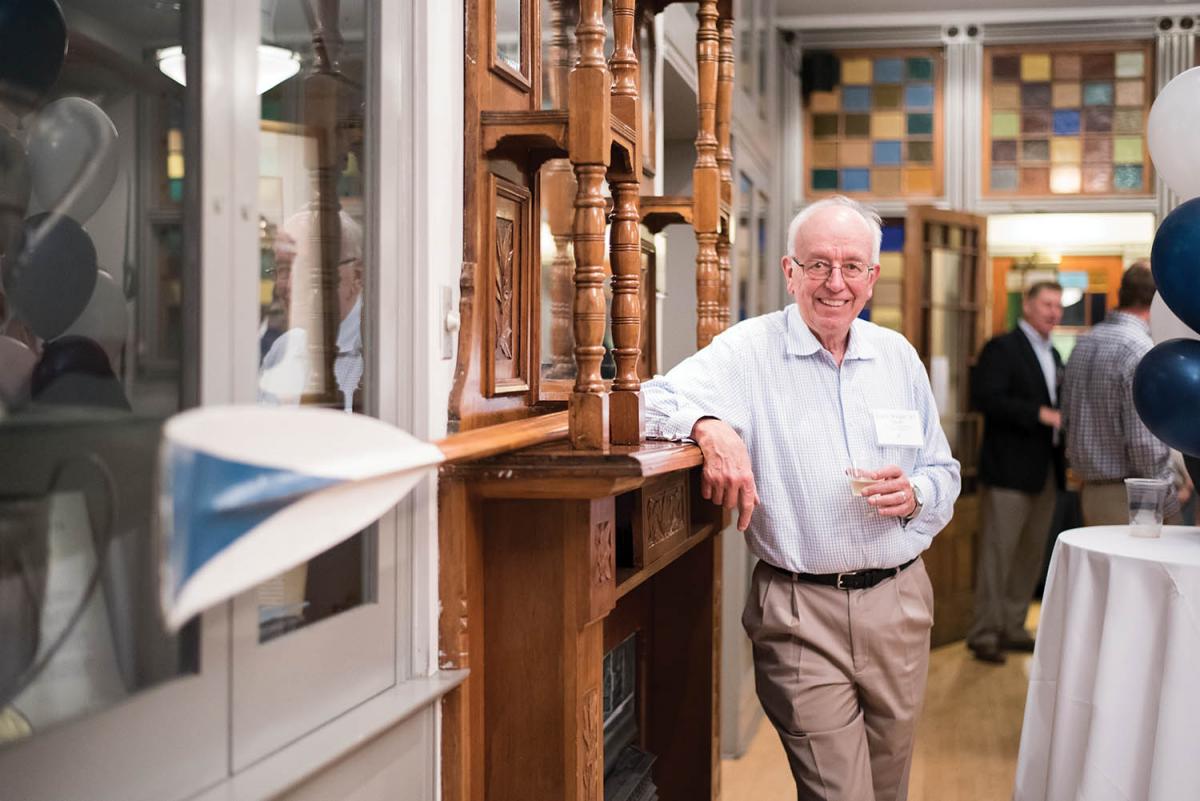 Frank Wright '67 stands by the oar he used during the 1966 Dad Veil Regatta