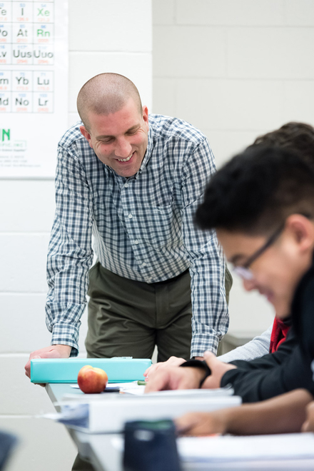 Kevin Pate talking with a student in class