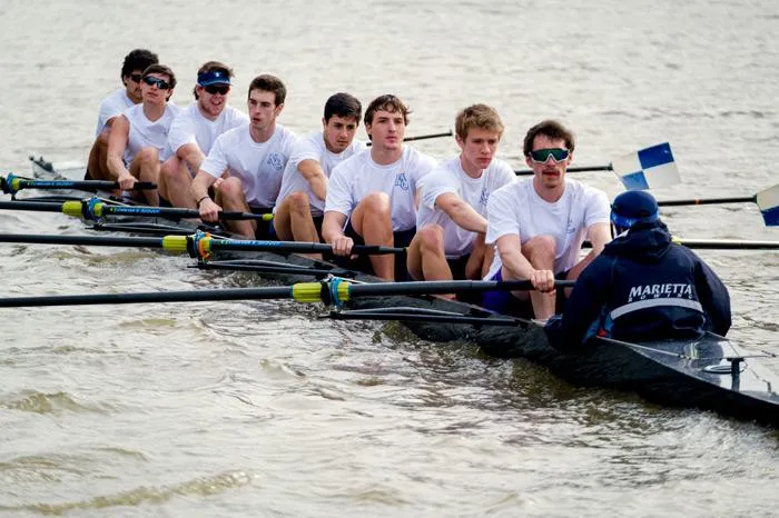 men rowing on the river