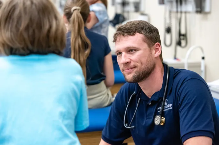 Male PA student speaking with a child