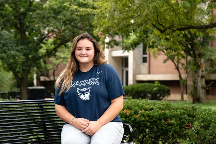 Savannah Flusche seated on a bench