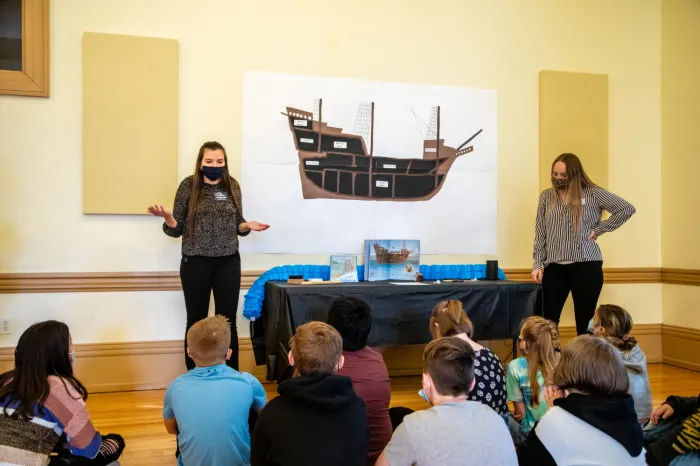 Education students speaking with fifth-graders