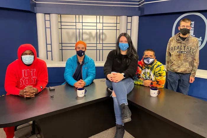 Masked students in the TV studio
