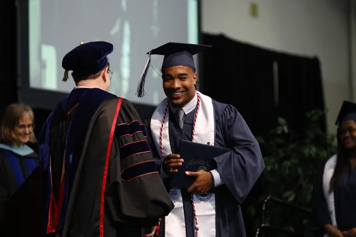 Male student receives diploma