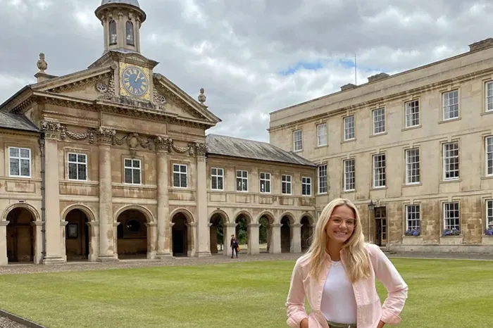 Student posing in front of building