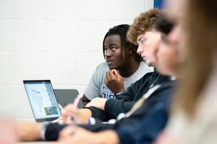 Male students listening in class