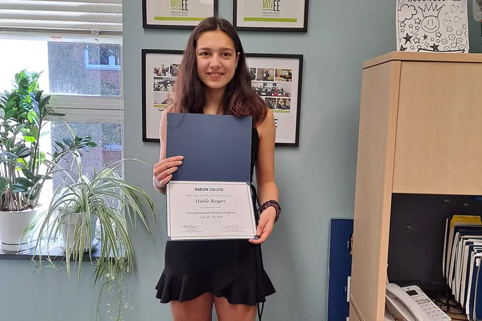 Haille Rogers holding certificate