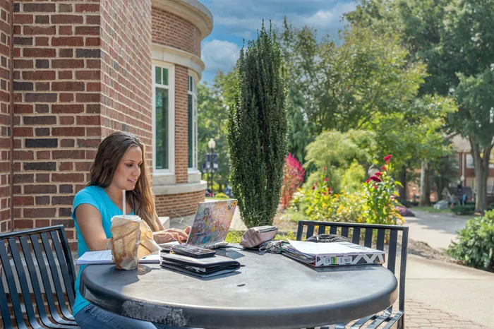 Female student studying outside