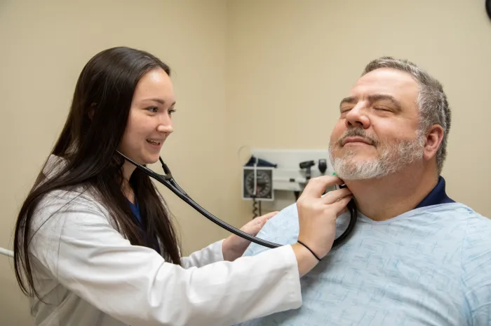 PA student practicing skills on a patient