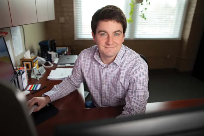 Charles Doan sitting at a desk