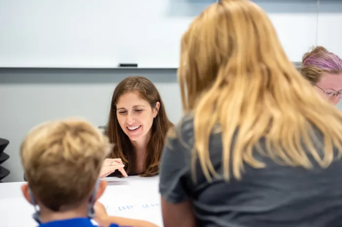 Education professor speaking with students
