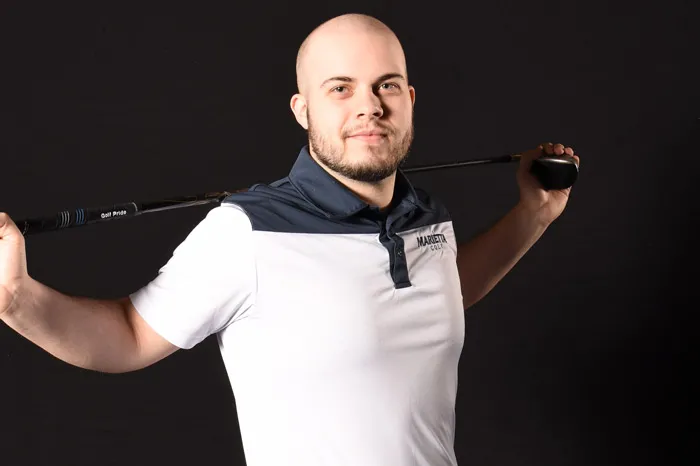 Male golfer with club over his shoulders