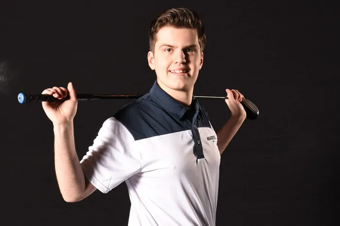 Male golfer with club over shoulders
