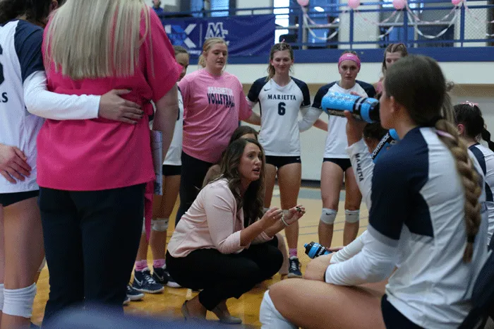 Coach Newman speaking with her team