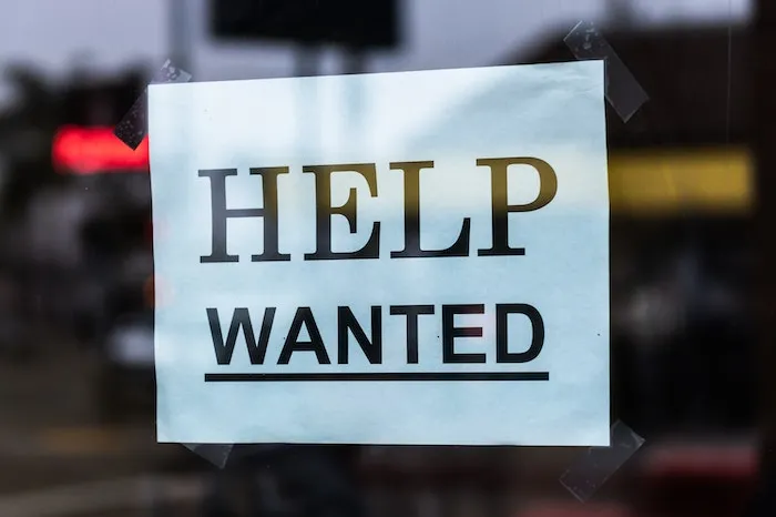 Help Wanted sign in a window
