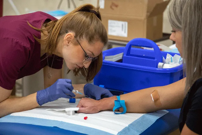 PA student drawing blood from a hand