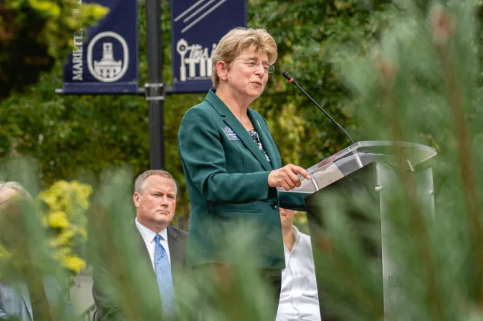 President Drugovich speaking at a podium