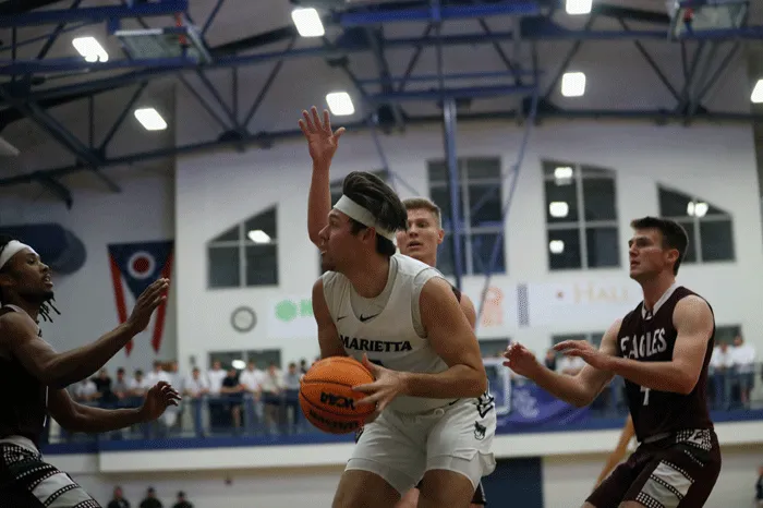 MC basketball player going up for a shot under the basket