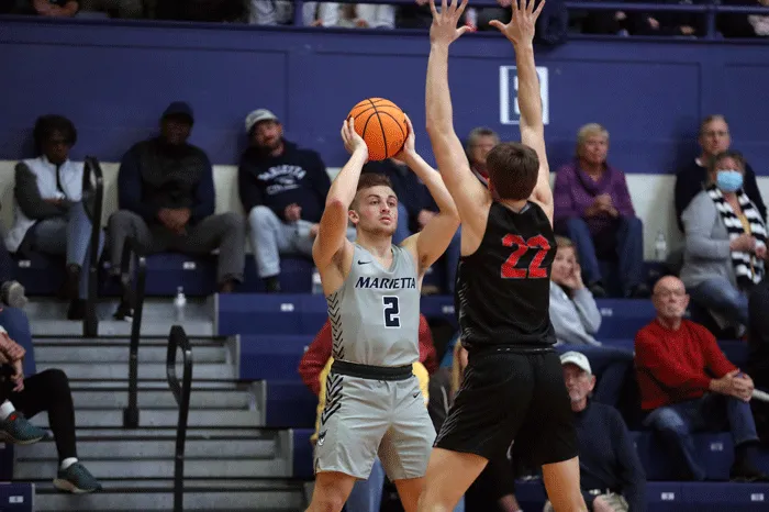 Basketball player looking to pass while being pressured