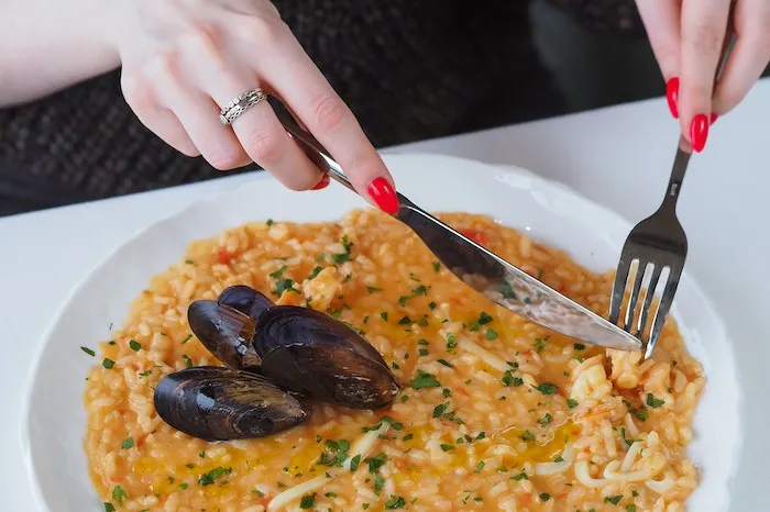 Woman cutting paella