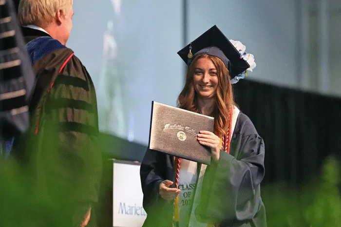 Female student receiving her diploma