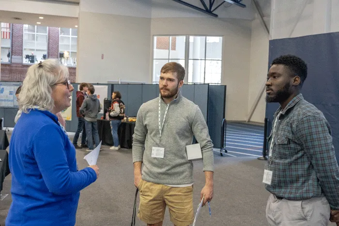 Students speak with an energy industry employee