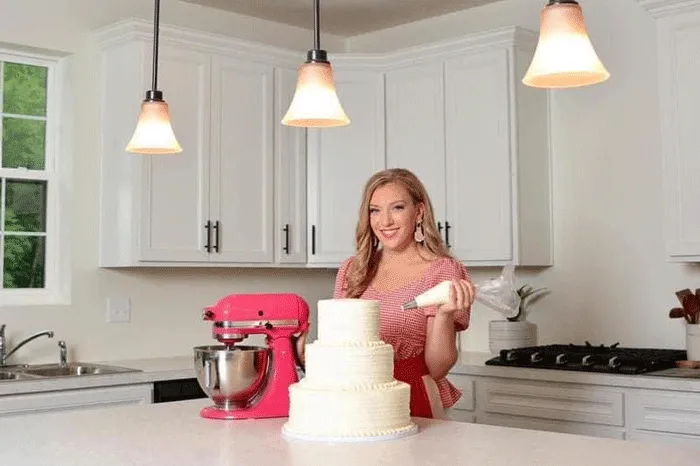 Bre Herrick in the kitchen with a cake