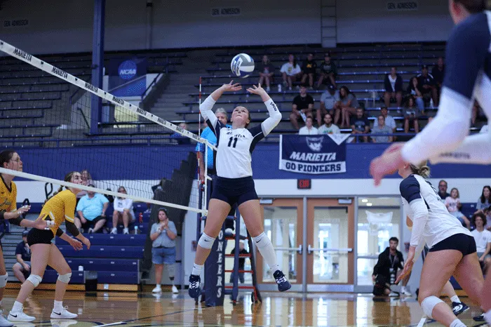 Emory Spitler setting the volleyball