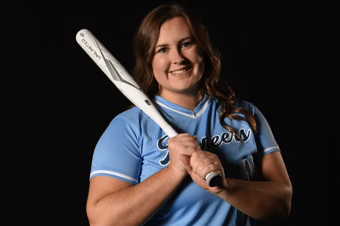 Softball player with bat on shoulder