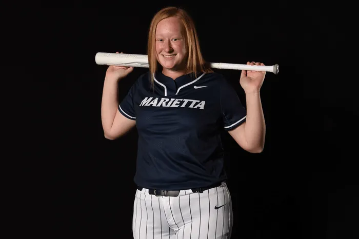Softball player with bat over shoulders