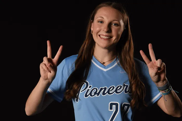 Softball player giving the peace sign