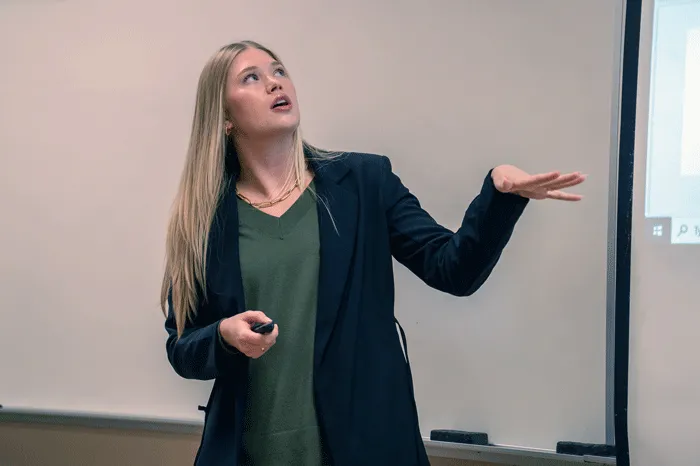 Maris Kiser speaking with a class