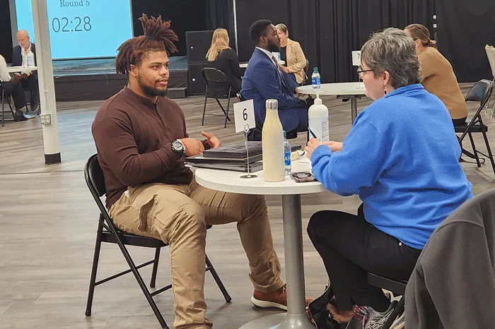 Male student speaking with an interviewer