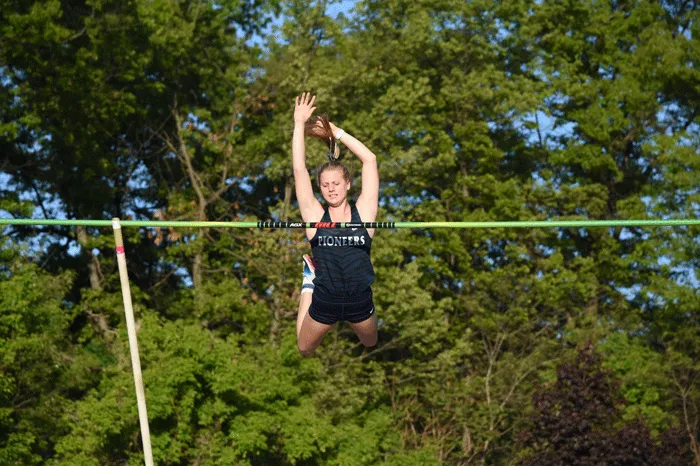 Pole vaulter clearing the bar