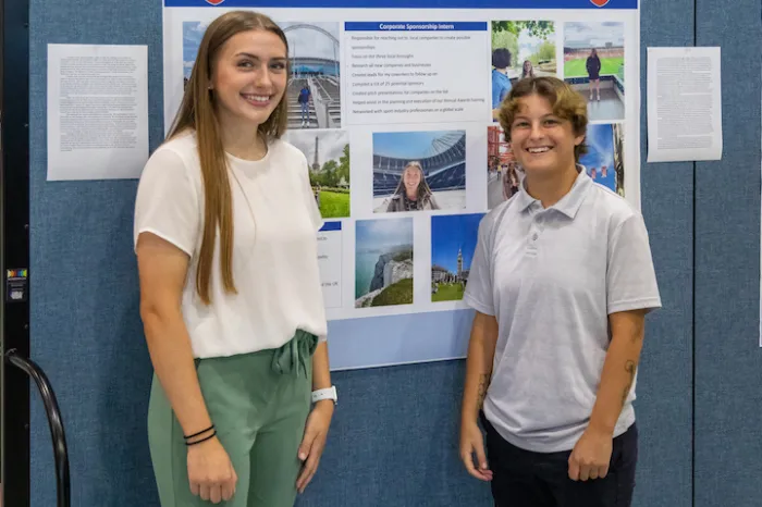Marietta College students pose in front of a poster during Experiential Education Day