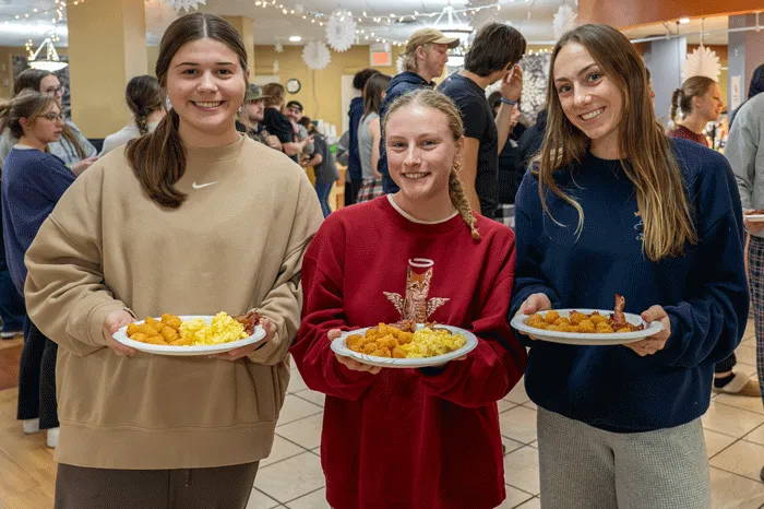 Students holding breakfast plates