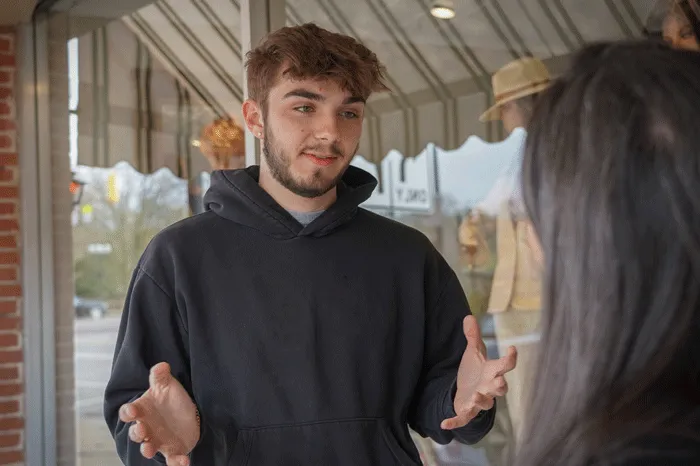 Student speaks with a downtown business owner